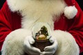 Santa Jim holds a nativity snowglobe